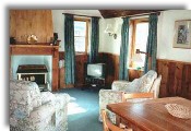 Cosy colourful living room with original old wood panelling throughout 
